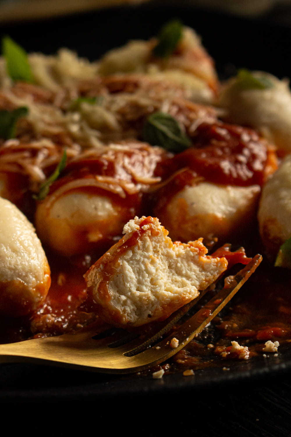 close no garfo mostrando um bolinho já partido e com o interior branco e granuloso a mostra